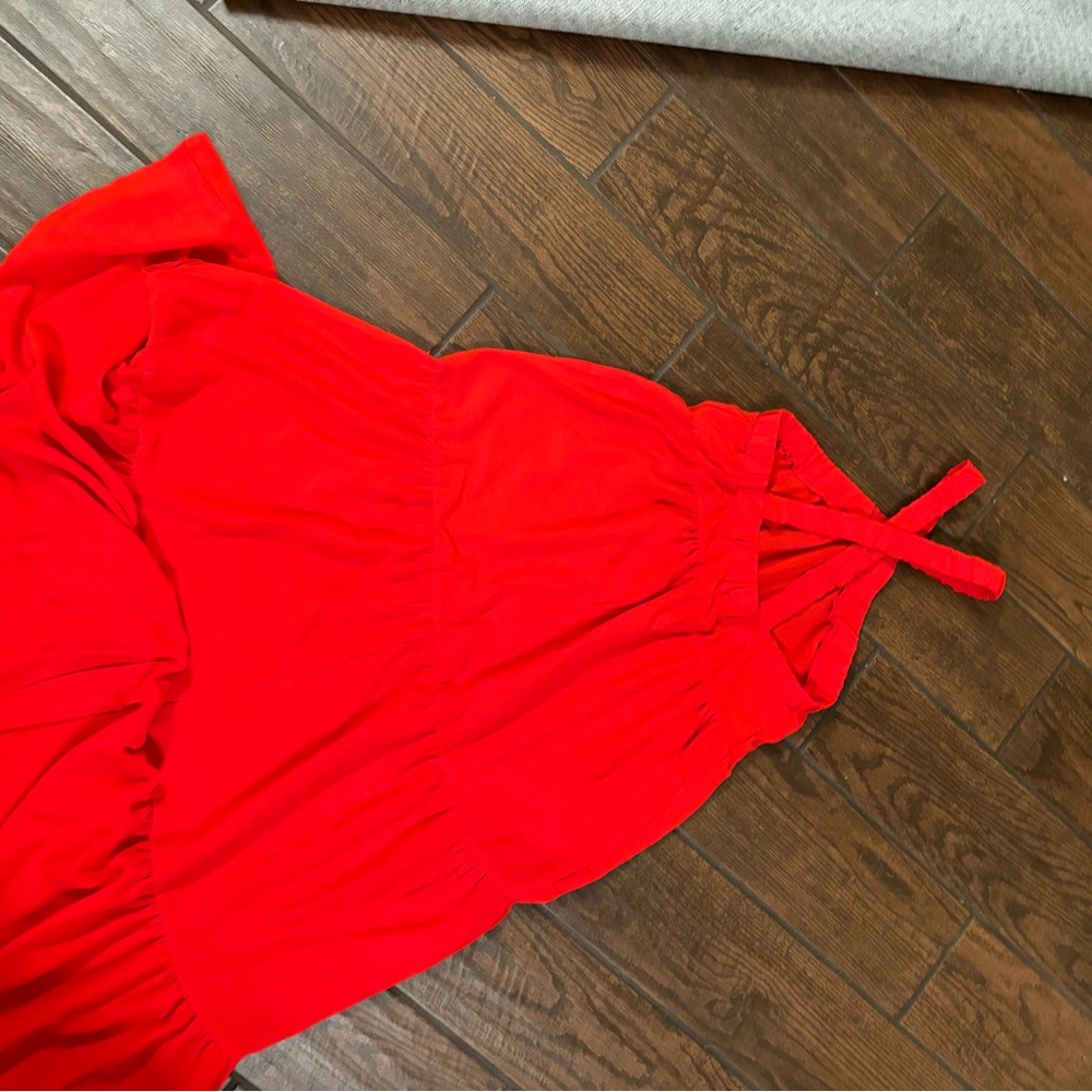 New- size medium red floor length sun dress. It cross crosses around the neck.